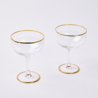 A Pair Of Karen Walker Gold Rimmed Champagne Coups