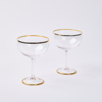 A Pair Of Karen Walker Gold Rimmed Champagne Coups