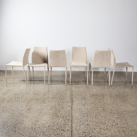 A Suite of Six Modern Dining Chairs Upholstered in Cream Fabric