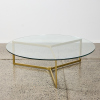 A Glass Coffee Table with a Tri-Leg Gold Coloured Base