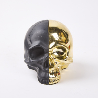 A Pair Of Skull Bookends Iin Black & Gold