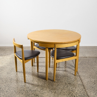 A Hans Olsen Roundette Style Dining Table With Four Nested Chairs