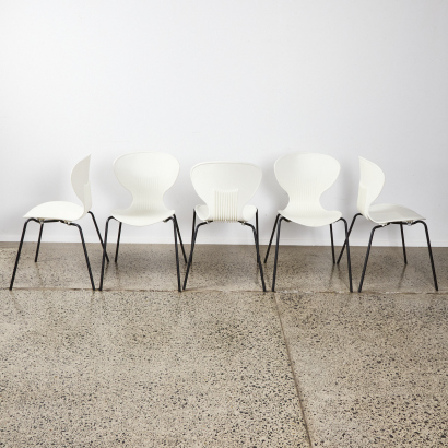 A Set of Five White Stacker Chairs