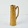 An Ambrico Crown Lynn Twig Handled Jug in Yellow