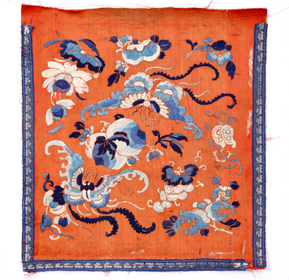 A Chinese Qing dynasty orange ground embroidered silk 'butterfly, fruit, flower' piece