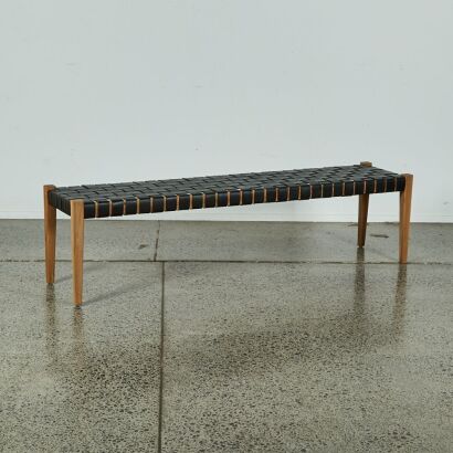 A Teak Framed Bench Seat With Black Leather Weaved Seat