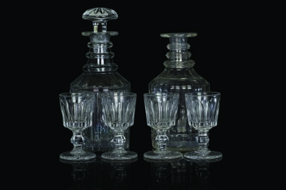 Two Georgian Deeply Cut Glass Triple Ring Neck Decanters and Four Sherry Glasses