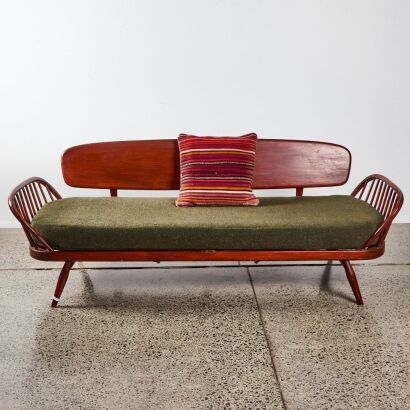 An Ercol Studio Daybed and Kilim Cushion