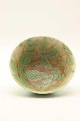 A Japanese 20th century green glazed flower bowl