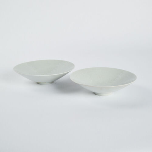 A pair of Chinese white glaze dark engraved conical dishes