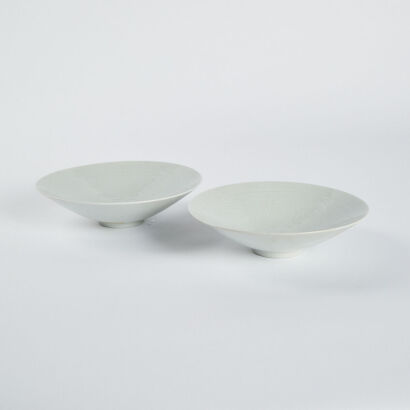 A pair of Chinese white glaze dark engraved conical dishes