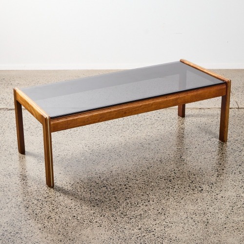 A Mid-Century Coffee Table With A Smoked Glass Top