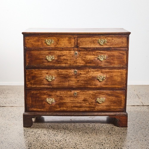 An Antique Chest of Drawers with Brass Fixtures