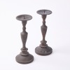 A Pair Of Cast Iron Candleholders