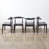 A Set of Four Elbow Chairs By Cintesi In Ebonised Oak