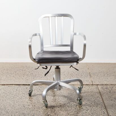 A Black Upholstered Chair on Castors