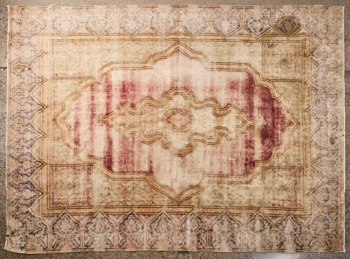 A Large Worn Out Hand Knotted Turkish Rug