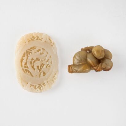 A Chinese 20th century reticulated white jade 'chi dragons' oval pendant and A Chinese 20th century rounded jade pendant of a child with a gourd