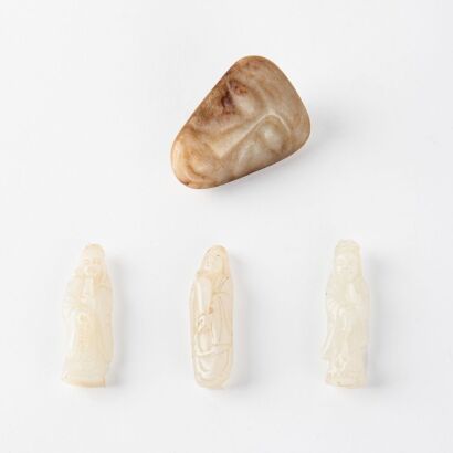 A Chinese Prehistoric style 'human face' jade carving and Three Chinese white jade carved Guanyin pendants