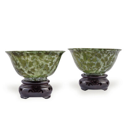 A Pair of Chinese Dark Green Jade Bowls on Wooden Stands