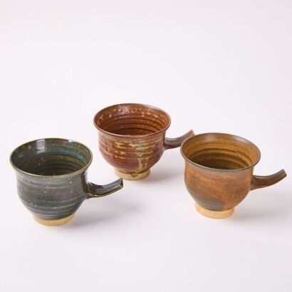 A Set Of Three Large Stem Handled Studio Pottery Cups