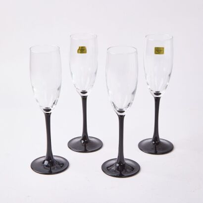 A Set of Four Luminarc Black Stemmed Flutes