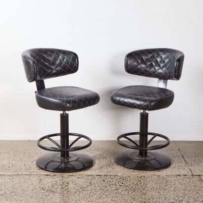 A Pair Of Barstools With Diamond Stitch Upholstery