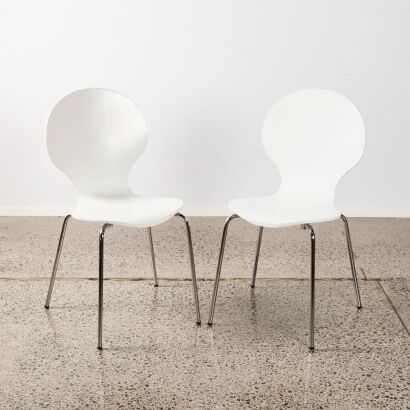 A Pair Of Formed Plywood Chairs In White With Chrome Base