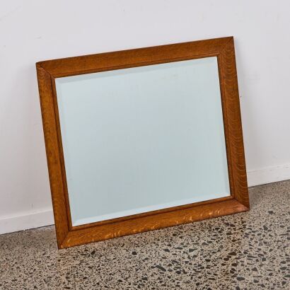 A Early 20th Century Beveled Mirror Set in a Rewarewa frame