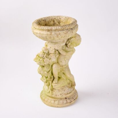 A Concrete Cherub Bird Bath