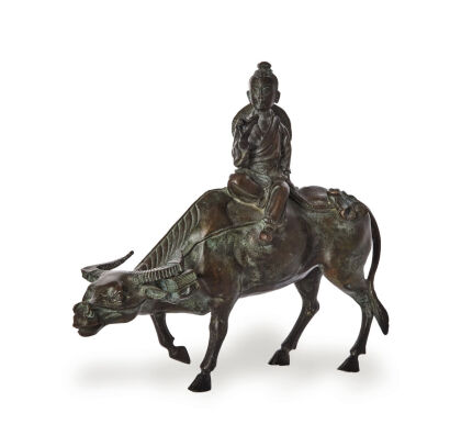 A Chinese Bronze Boy and Cow Statue