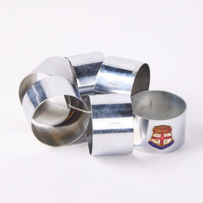 A Set of Six Vintage Chrome Napkin Rings with Fijian Crest Enamel Plaques