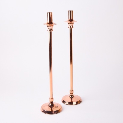A Pair of Copper Coloured Candle Holders