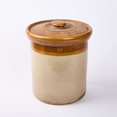 A Stoneware Pot With A Lid