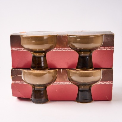 A Set Of Eight Boxed Kaaru Smoked Glass Champagne Coupes