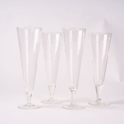 A Set Of Four Etched Champagne Coupes