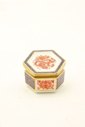 A small red enamels 'dragon' hexagonal lidded box