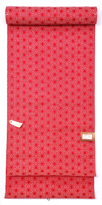 A roll of Japanese red hexagonal brocade fabric