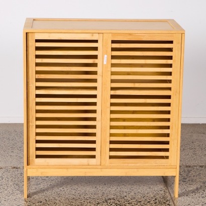 A Bamboo Storage Unit With Slatted Doors