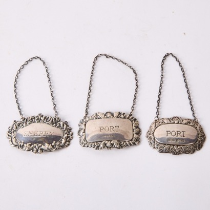 A Collection of Three Silver Port and Sherry Labels