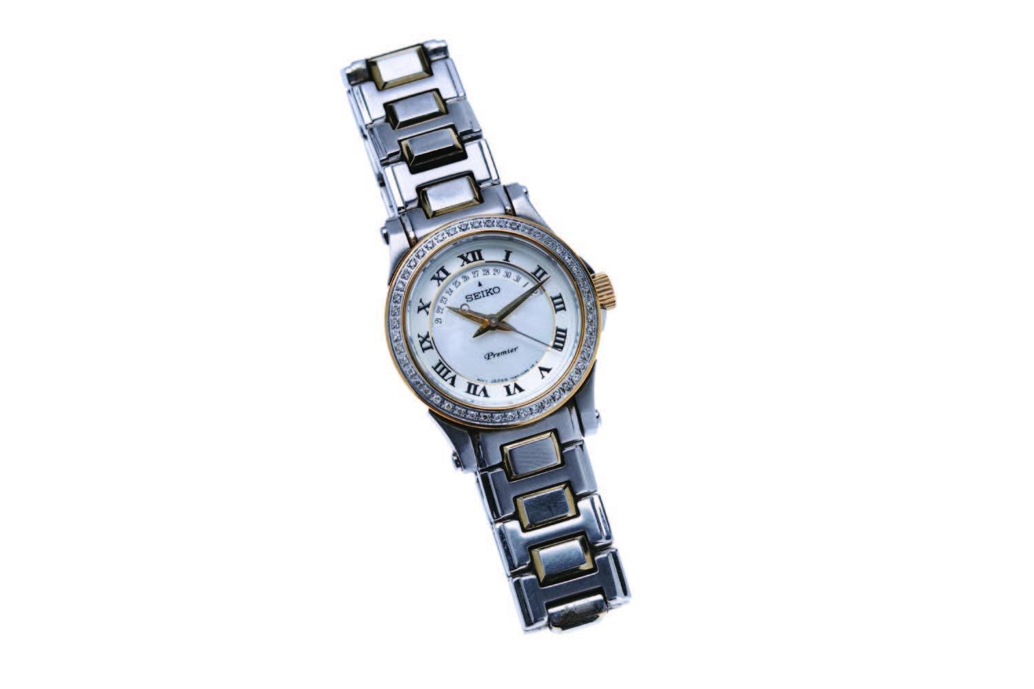 A Lady's two tone diamond wristwatch, Seiko. Quartz. 28mm. Ref: SXD774P1.  Case number 7N82-ODAD. White dial with calendar, painted black Roman  numerals and centre sweep seconds. Diamond set bezel. Case, dial movement