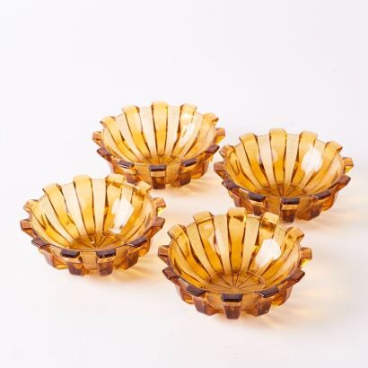 A Set of Four Amber Art Deco Pressed Glass Bowls