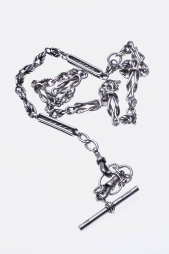 A sterling silver watch chain of fancy link design, hung with a T-bar and swivels. Weight 45.8 grams. Length 50cm.