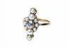 An antique style pearl and diamond ring, the bezel set old brilliant cut diamond surrounded by half pearls. 18ct yellow gold. Weight 3.55 grams. Size K.
