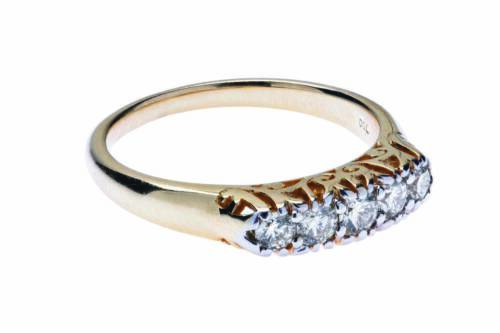 A diamond bridge ring, set five across with round modern brilliant cut diamonds. Estimated total diamond weight 0.45 carat. 18ct yellow gold. Weight 4.50 grams. Size O&frac12;.
