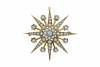 A Victorian pearl and diamond brooch, of starburst design, set throughout with small half pearls and a central old brilliant cut diamond. 15ct yellow gold. Weight 8.16 grams. Diameter 4cm.