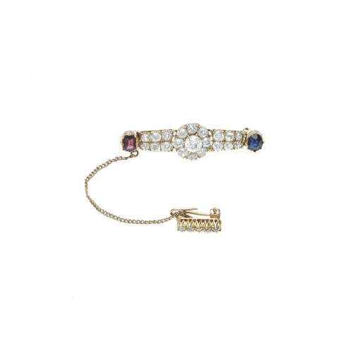 A Victorian sapphire and diamond bar brooch, the central old brilliant cut diamond cluster set on a diamond bar with sapphire and garnet terminals. 18ct yellow gold. Weight 9.69 grams. Length 44mm.