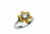 A yellow and white diamond cluster ring, the central white brilliant cut diamond of estimated weight 0.50 carat, surrounded by six yellow round brilliant cut diamonds of estimated total diamond weight 0.98 carats. 18ct white gold. Weight 6.4 grams. Size O