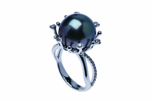 A Tahitian pearl and diamond ring, the central round pearl measuring 13mm in an abstract design mount. Estimated diamond weight 0.25 carat. 18ct white gold. Weight 9.28 grams. Size M. 