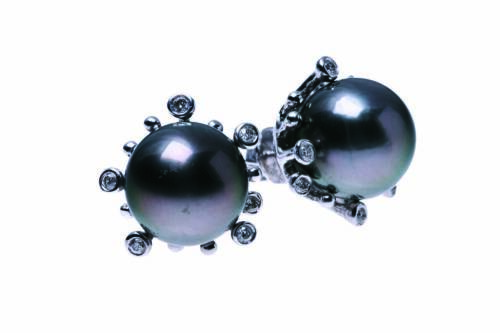 A pair of Tahitian pearl and diamond earrings, each central pearl measuring 8.5mm in an abstract design mount. Estimated diamond weight 0.10 carat. 18ct white gold. Weight 6.83 grams. Post and butterfly attachments.